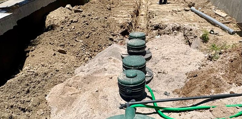 Tanks connected in an open trench